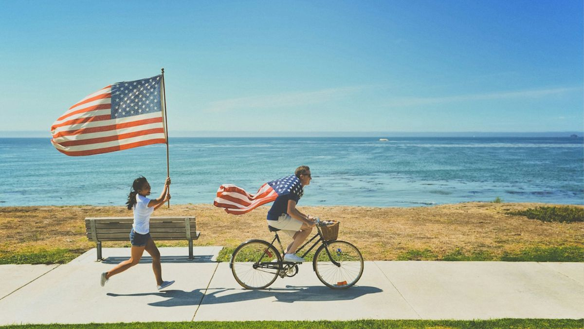 When did 'God bless the USA' come out, and who wrote and signed 'Proud to Be an American'?